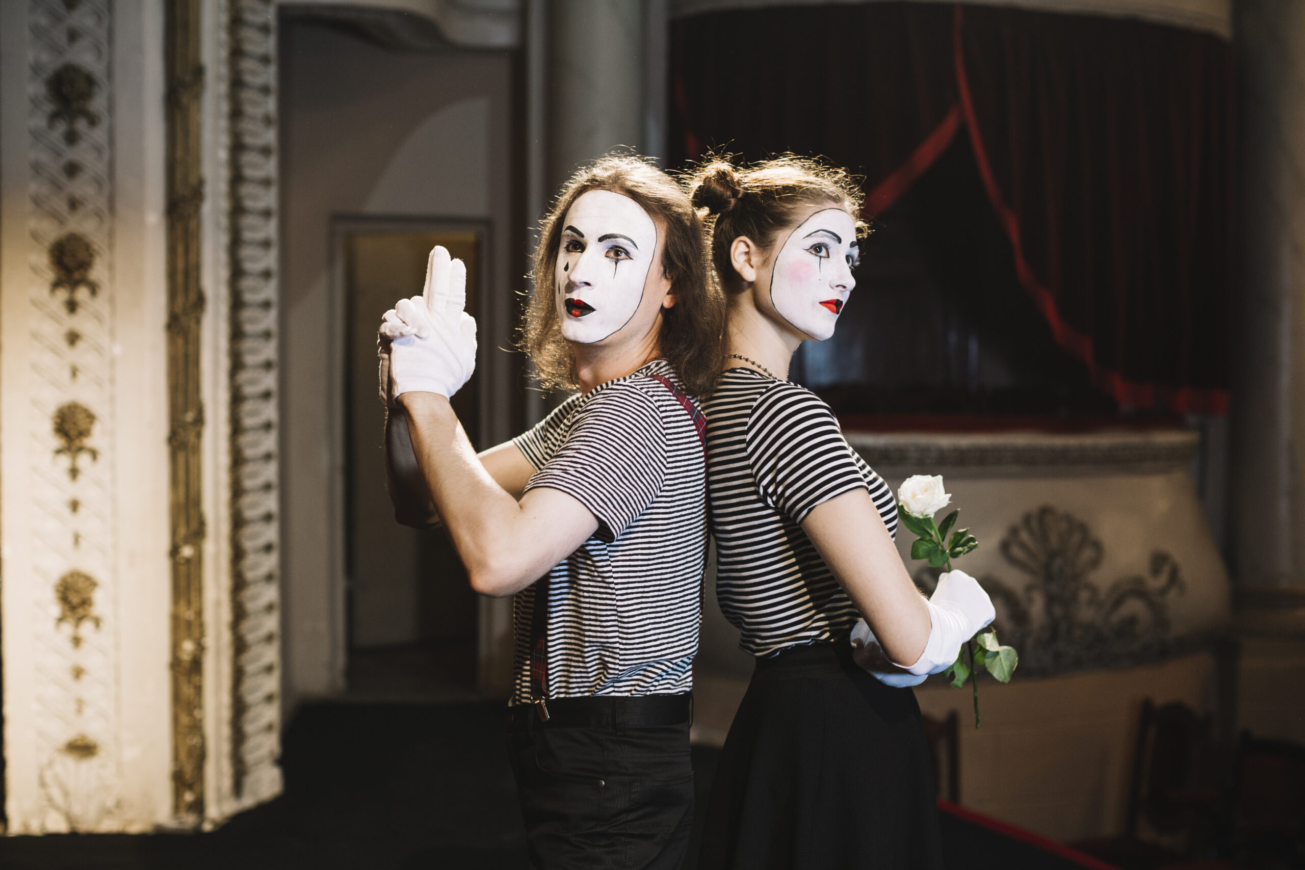male mime with hand gun gesture female mime holding rose standing back back scaled